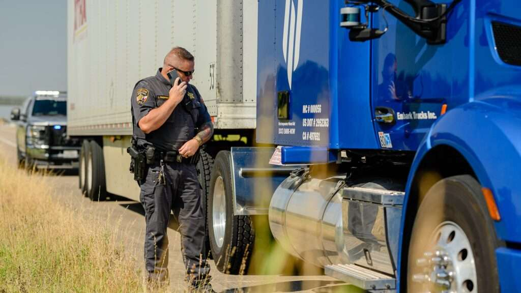 Roadside officer beside a commercial truck